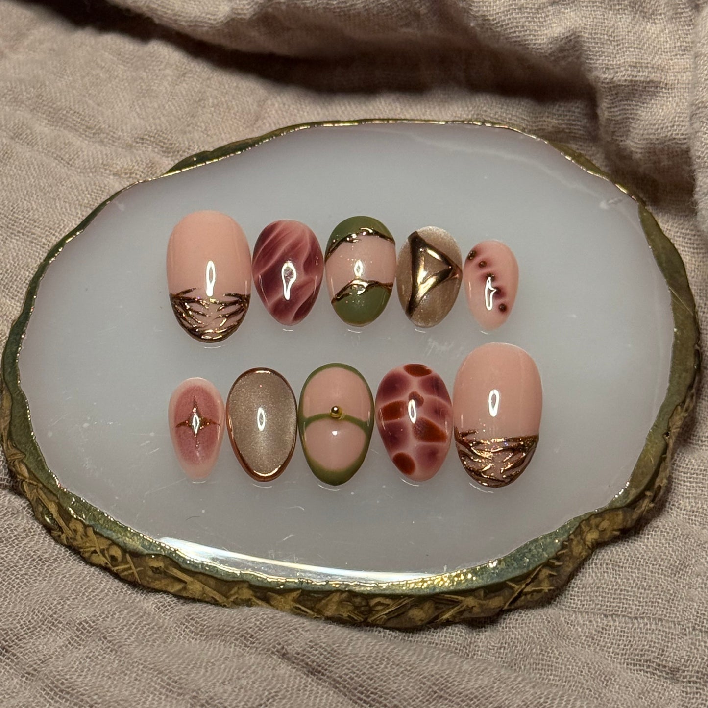 handmade abstract press on nails with deep fall reds, browns and green designs and chrome accents, reusable, custom handmade press on nails, easy at-home manicure