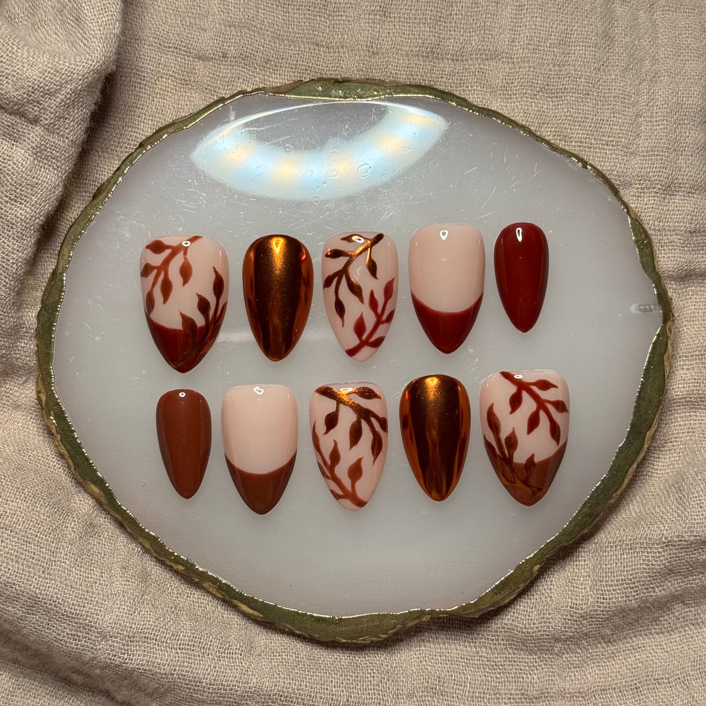 handmade brown and maroon press on nails with orange chrome leaf designs