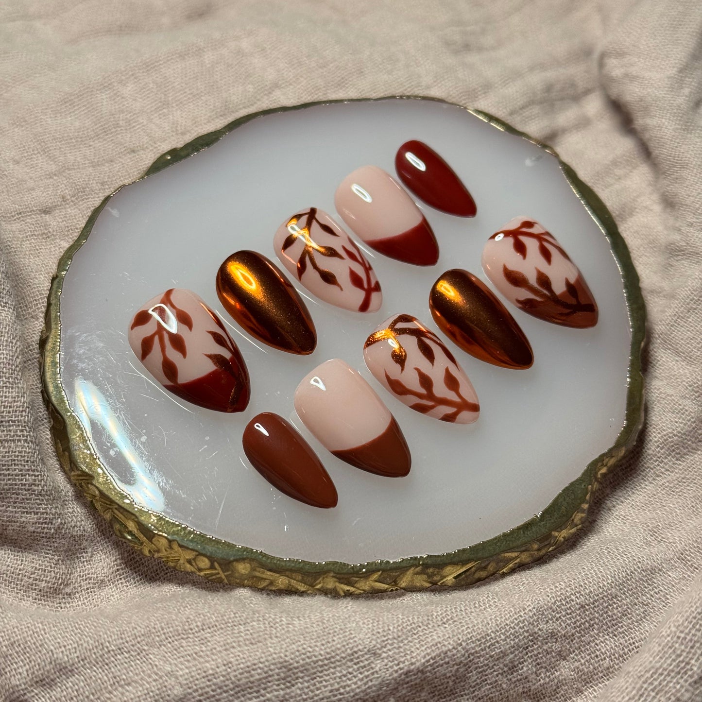 handmade brown and maroon press on nails with orange chrome leaf designs