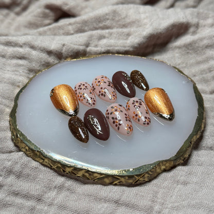 handmade deep maroon and shimmery orange press on nails with floral, chrome and sparkle accents, reusable, custom handmade press on nails, easy at-home manicure