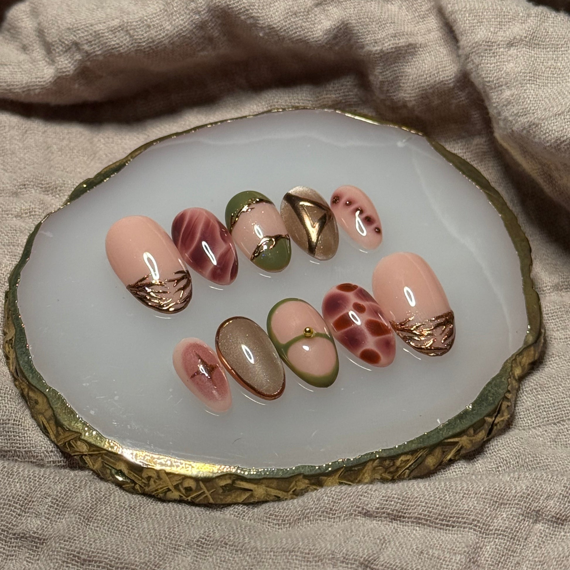 handmade abstract press on nails with deep fall reds, browns and green designs and chrome accents, reusable, custom handmade press on nails, easy at-home manicure