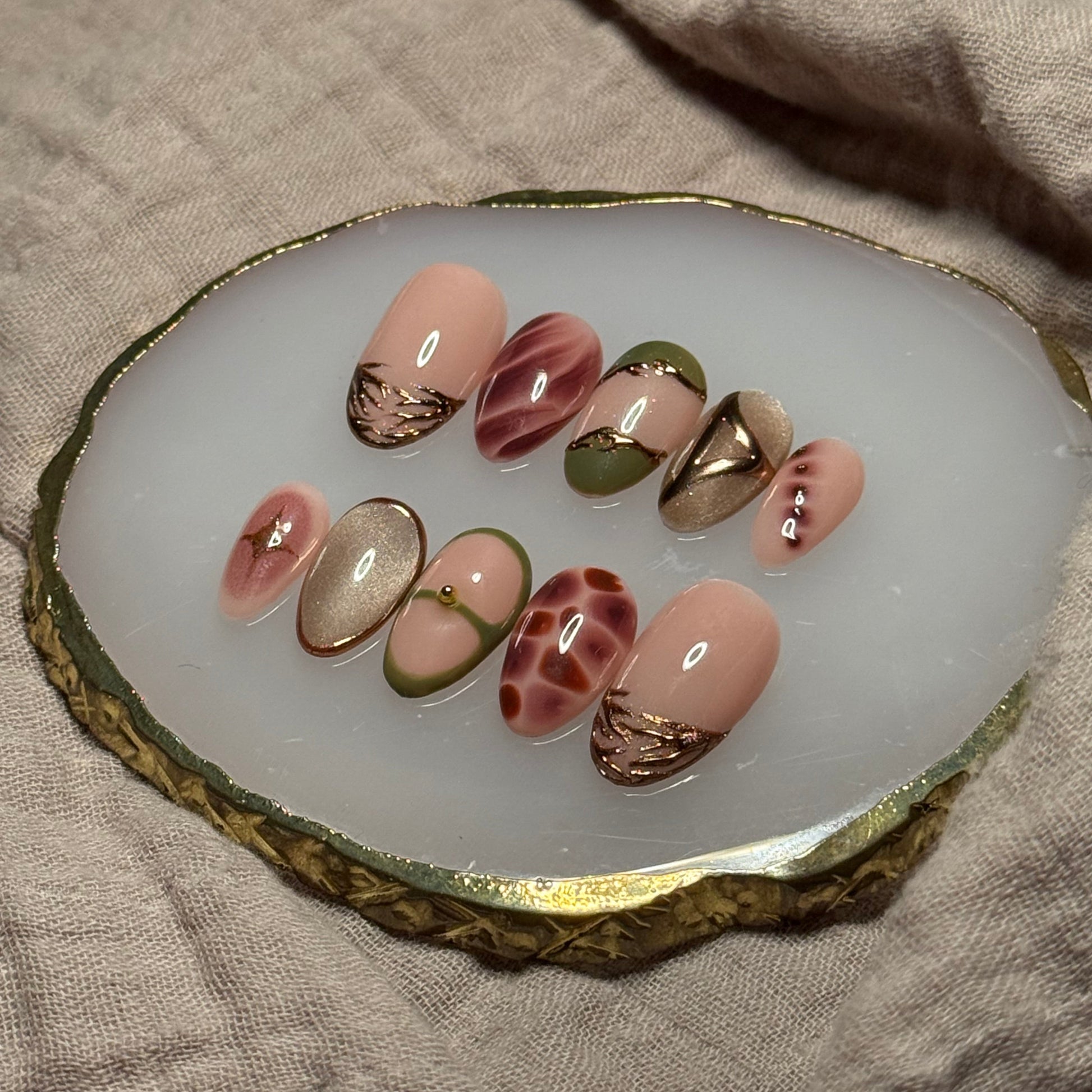 handmade abstract press on nails with deep fall reds, browns and green designs and chrome accents, reusable, custom handmade press on nails, easy at-home manicure