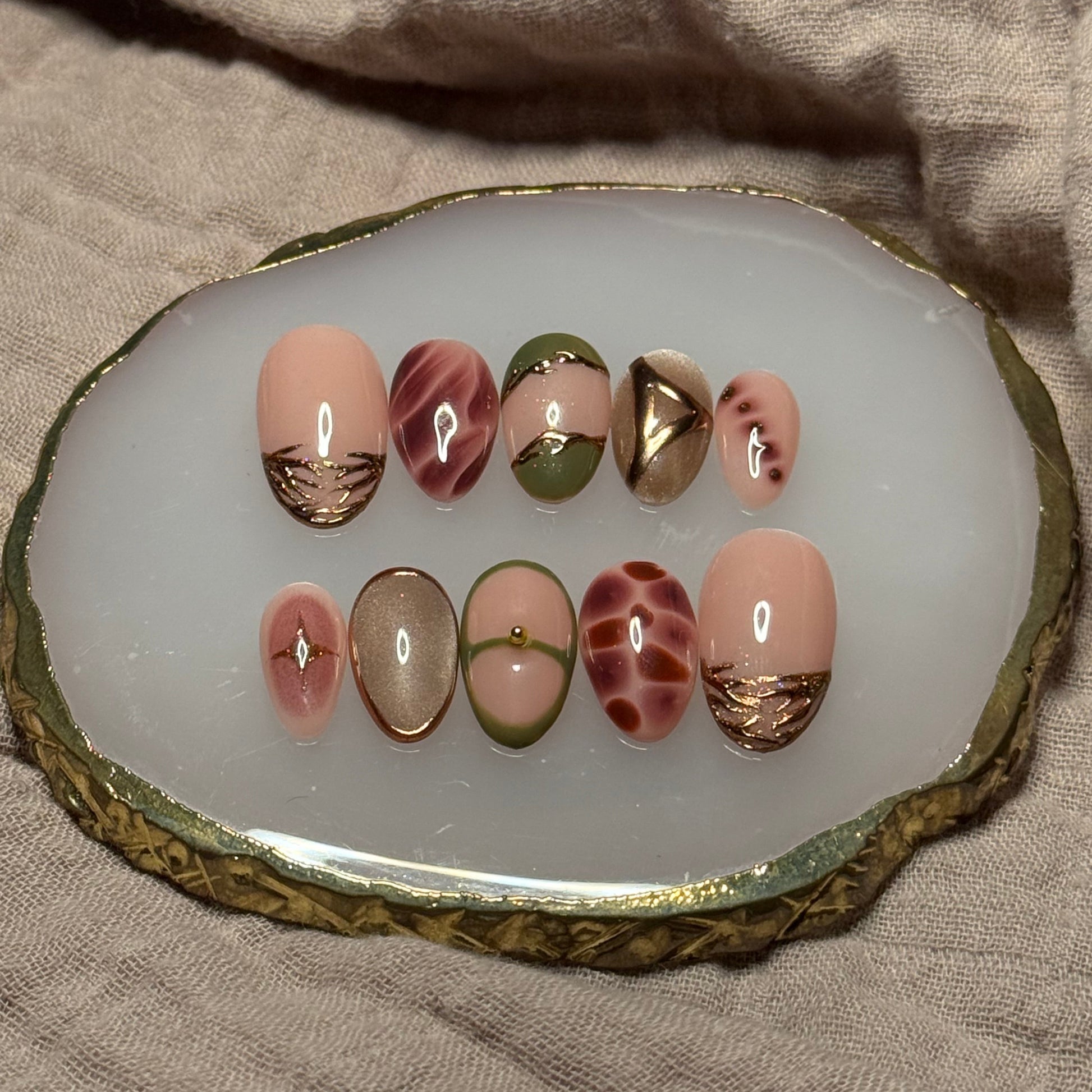 handmade abstract press on nails with deep fall reds, browns and green designs and chrome accents, reusable, custom handmade press on nails, easy at-home manicure