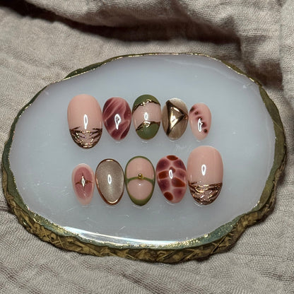 handmade abstract press on nails with deep fall reds, browns and green designs and chrome accents, reusable, custom handmade press on nails, easy at-home manicure