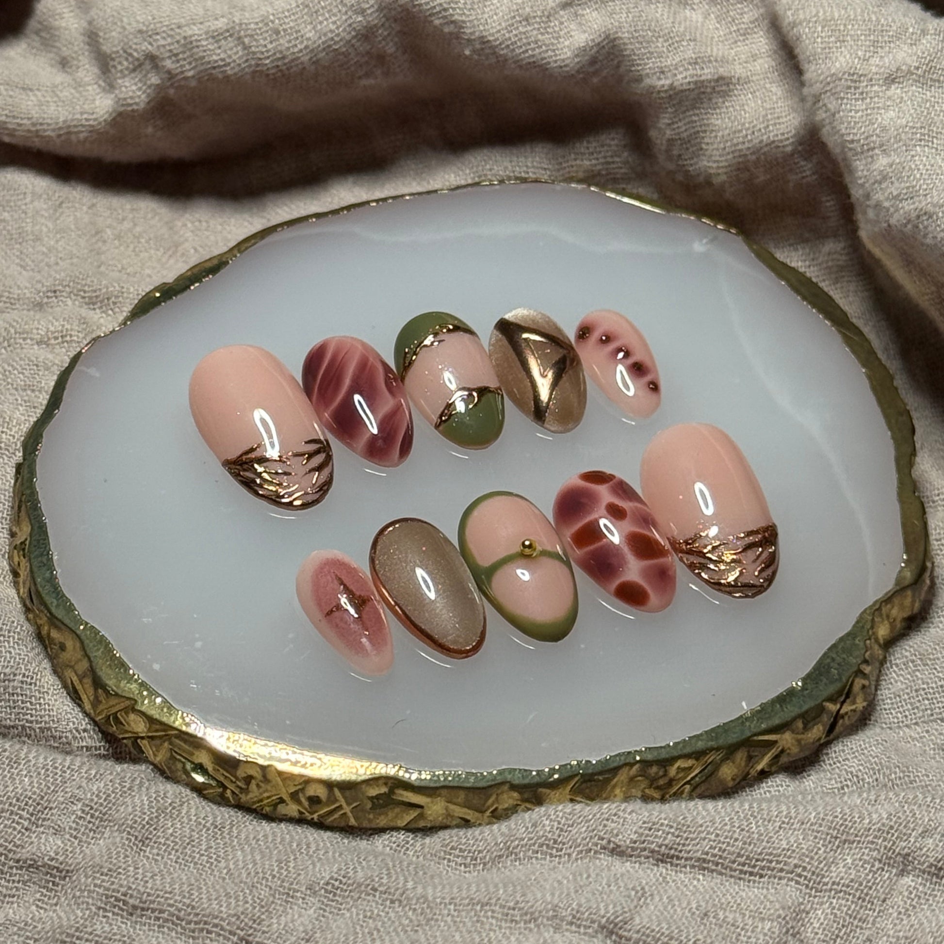 handmade abstract press on nails with deep fall reds, browns and green designs and chrome accents, reusable, custom handmade press on nails, easy at-home manicure