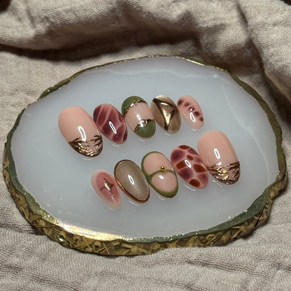 handmade abstract press on nails with deep fall reds, browns and green designs and chrome accents, reusable, custom handmade press on nails, easy at-home manicure